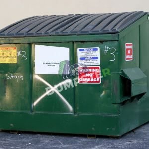Yard Dumpster (2) A green dumpster covered in colorful stickers, adding a fun touch to an otherwise ordinary trash can.